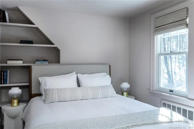 a bedroom with a bed and window