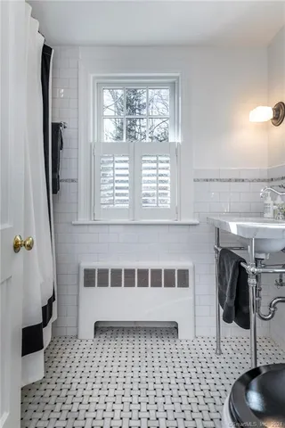 a bathroom with a sink a mirror and a shower