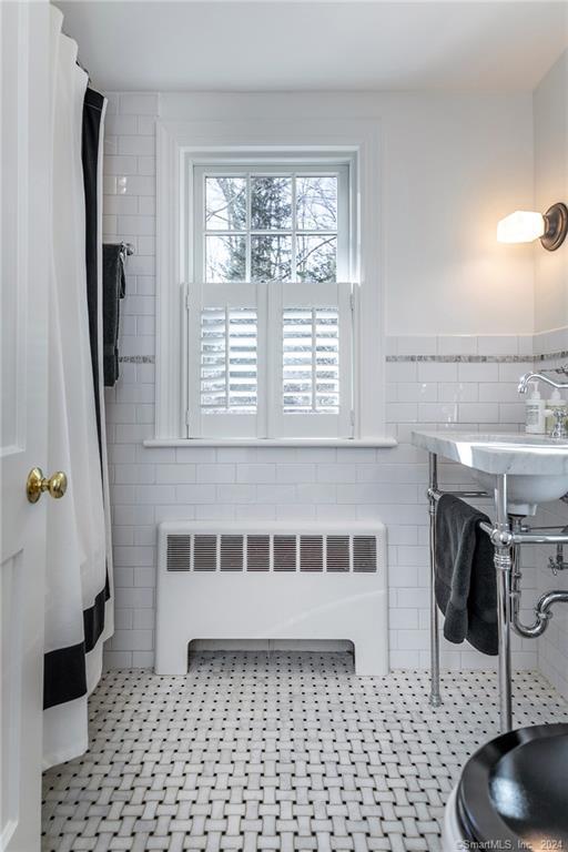 23 Cook Street Washington, CT 06794 - Photo 35 of 39 a bathroom with a sink a mirror and a shower
