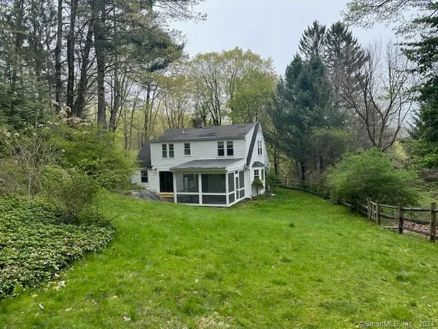 an aerial view of a house with a big yard
