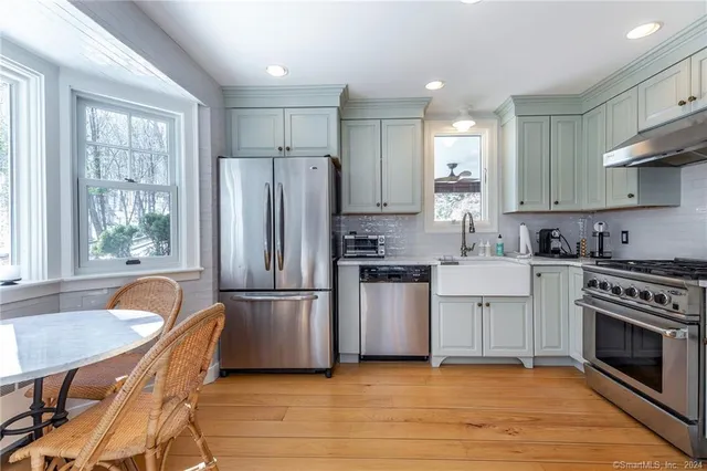 a kitchen with a stove a sink and a refrigerator