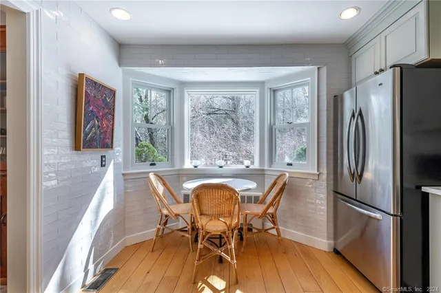 a view of a dining room with furniture window and wooden floor