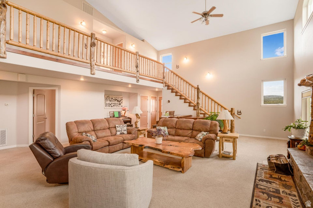 48 South Sage Road Pine Valley, UT 84781 - Photo 14 of 61 Expansive living area with a vaulted ceiling, wood-finish staircase and upper railing, recessed lighting, and high-set windows