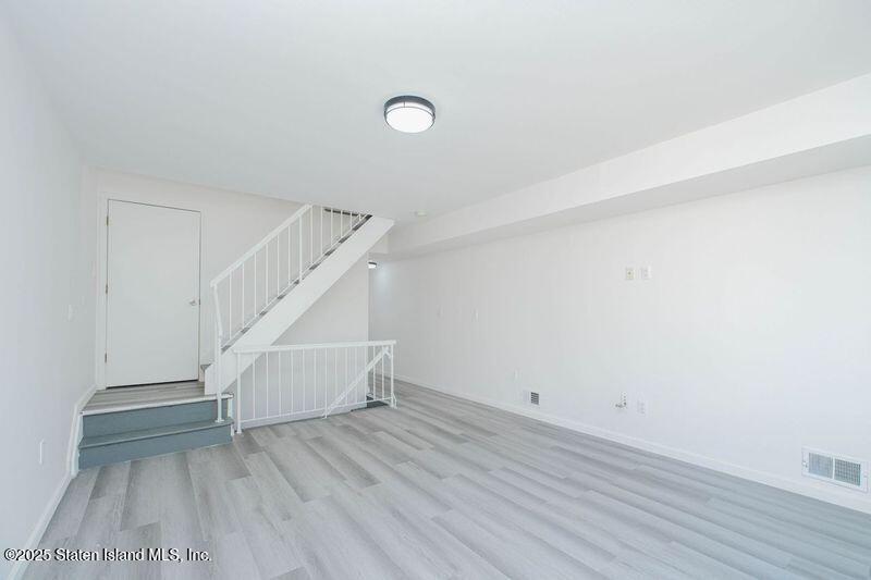 23 Vogel Loop Staten Island, NY 10314 - Photo 11 of 24 a view of entryway and hall with wooden floor