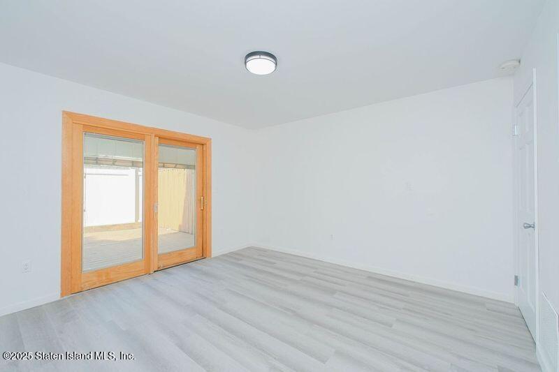 23 Vogel Loop Staten Island, NY 10314 - Photo 5 of 24 a view of an empty room and wooden floor