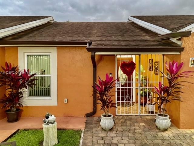 a front view of a house with outdoor seating