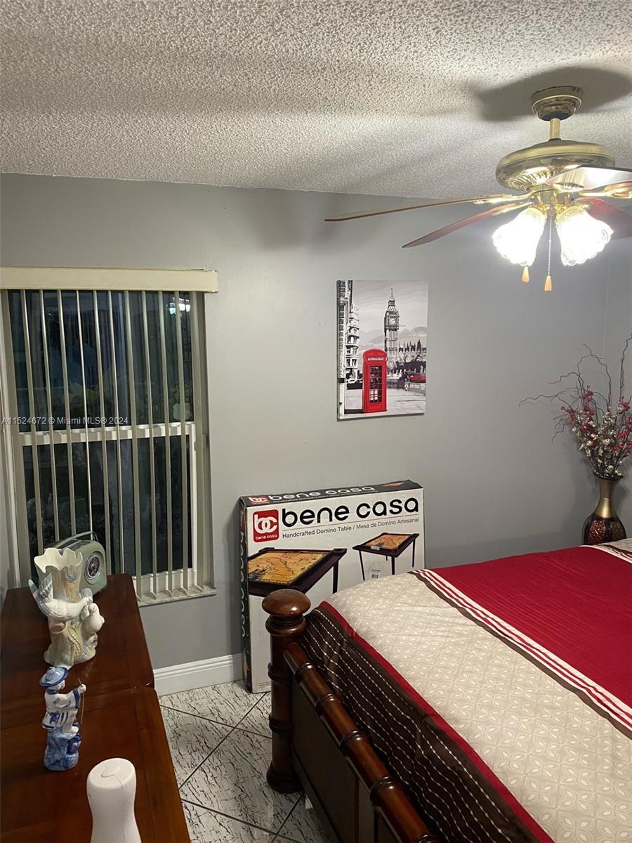 Goulds Miami, FL 33177 - Photo 14 of 18 a bedroom with furniture and a chandelier