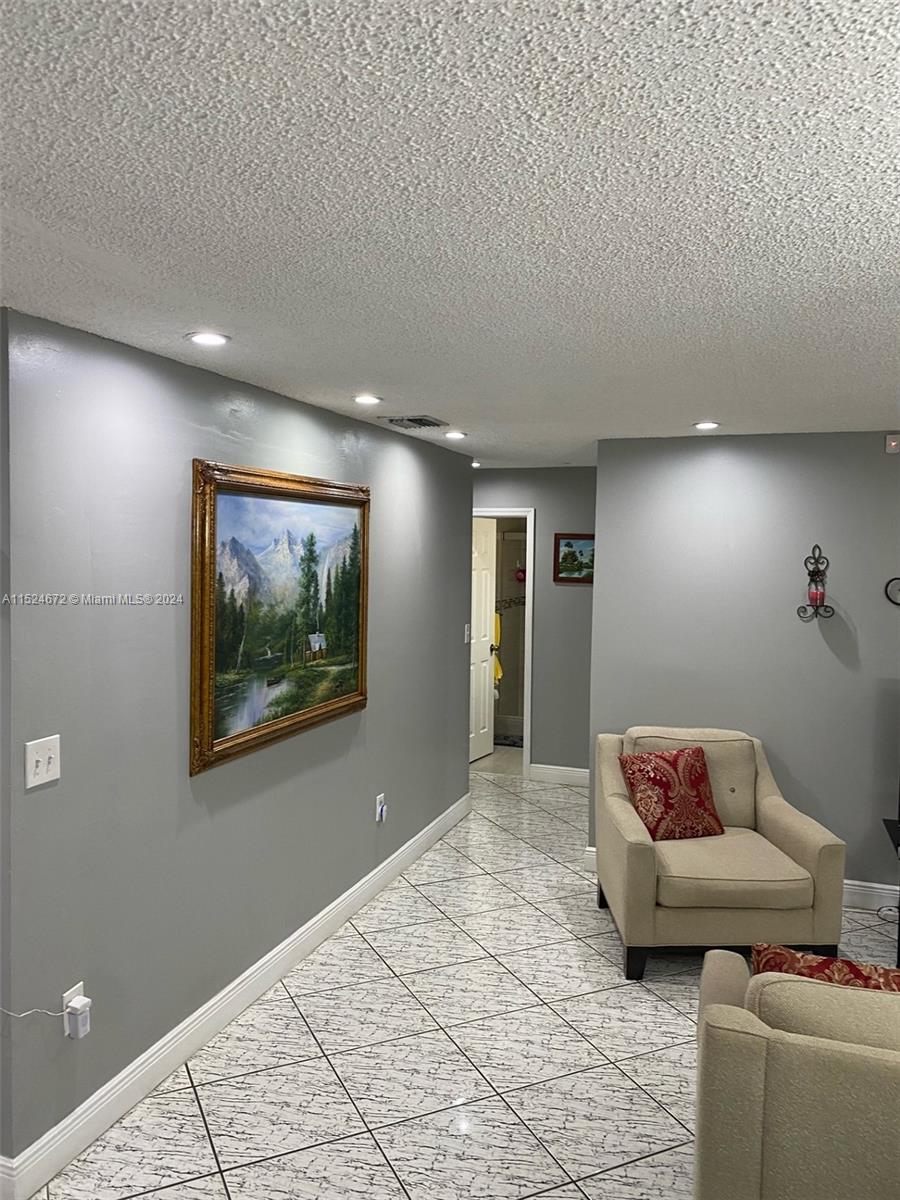 Goulds Miami, FL 33177 - Photo 16 of 18 a hallway with a couch and a couch