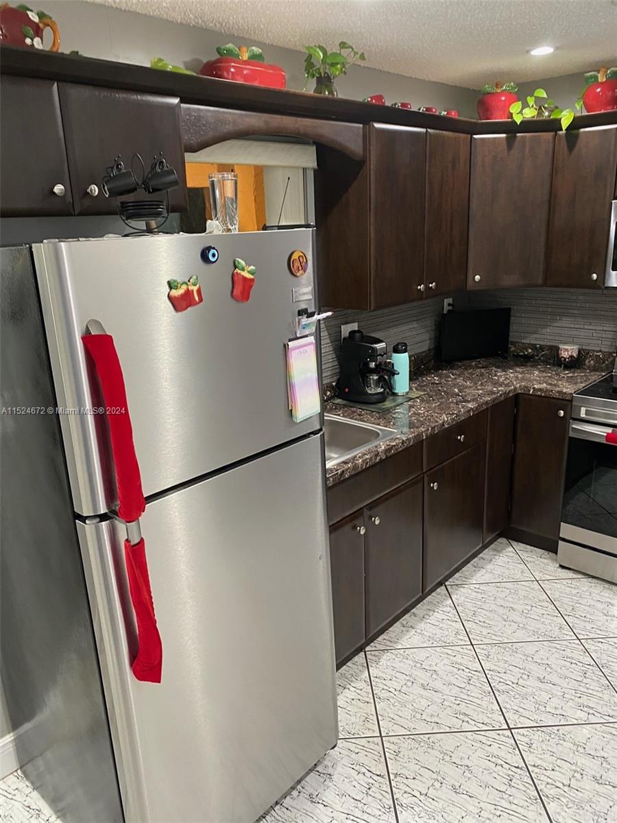 Goulds Miami, FL 33177 - Photo 9 of 18 a kitchen with a sink a refrigerator and cabinets