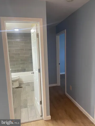 a bathroom with a double vanity sink toilet and a mirror
