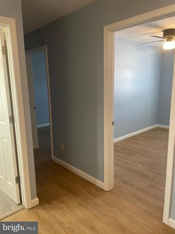 a view of a room with wooden floor and furniture