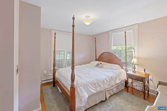 a bedroom with a bed lamp and a window