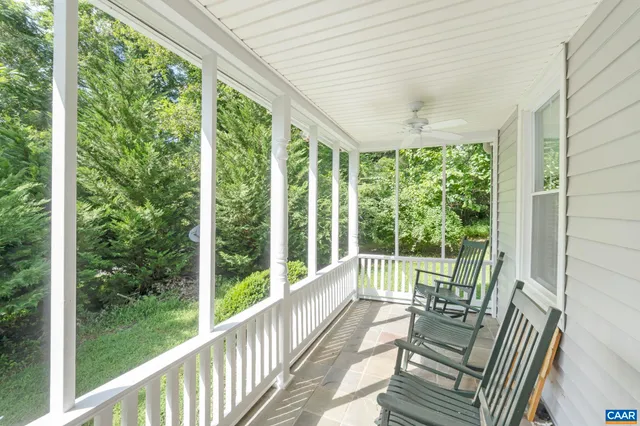 a view of a porch with furniture and wooden deck
