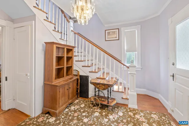 a view of entryway bedroom and hall with wooden floor