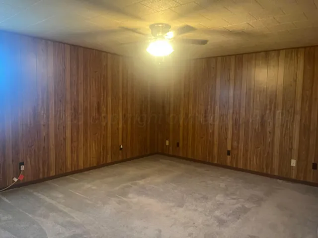 a view of an empty room with wooden walls
