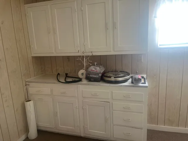 a kitchen with white cabinets and a sink