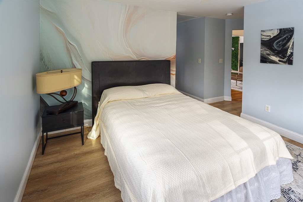 1364 High Street, Unit 1 Westwood, MA 02090 - Photo 11 of 16 a bedroom with a bed and cabinets