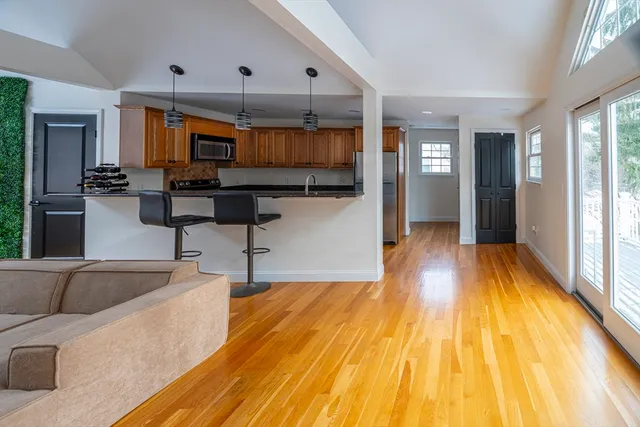 a kitchen with stainless steel appliances kitchen island granite countertop a sink window and cabinets