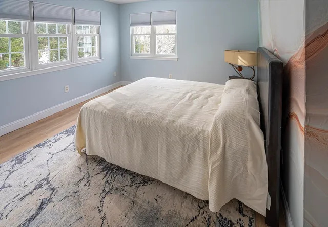 a bed sitting in a bedroom next to a window