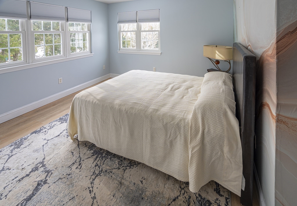1364 High Street, Unit 1 Westwood, MA 02090 - Photo 10 of 16 a bed sitting in a bedroom next to a window