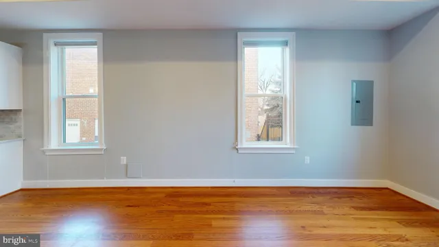 a view of a room with wooden floor and windows