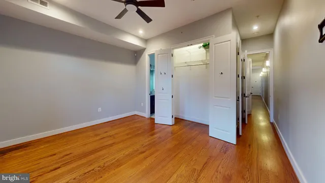 a view of a hallway with wooden floor