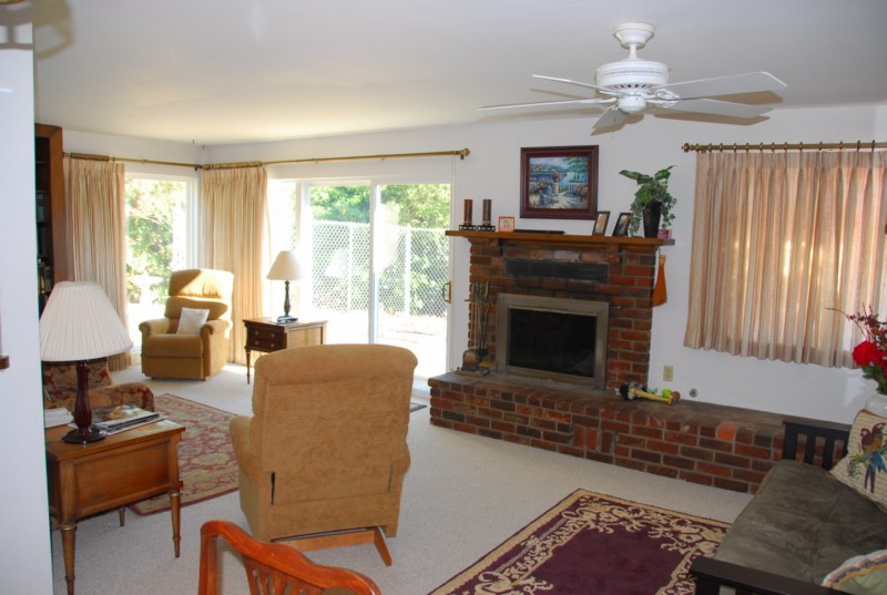 3155 Eucalyptus Hill Road Montecito, CA 93108 - Photo 3 of 10 a living room with furniture a large window and a fireplace