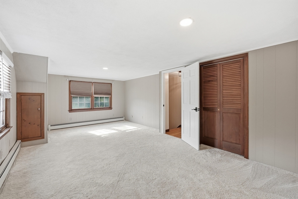 28 Spring Road Westborough, MA 01581 - Photo 26 of 42 a view of an empty room with a fireplace and a window