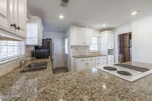 a kitchen with refrigerator stove microwave and cabinets