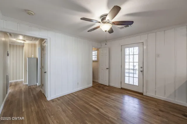 wooden floor in an empty room with a window