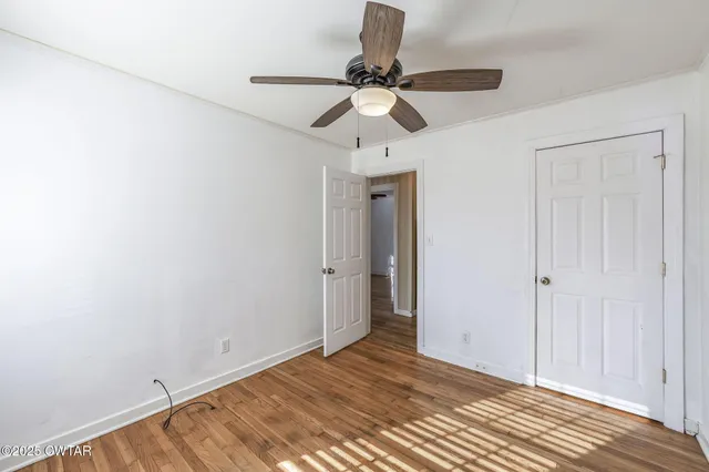 a view of an empty room and wooden floor