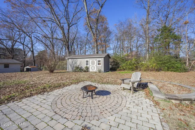 a view of house with backyard and trees