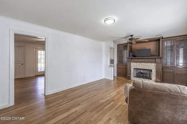 a view of a livingroom with an empty space and a fireplace
