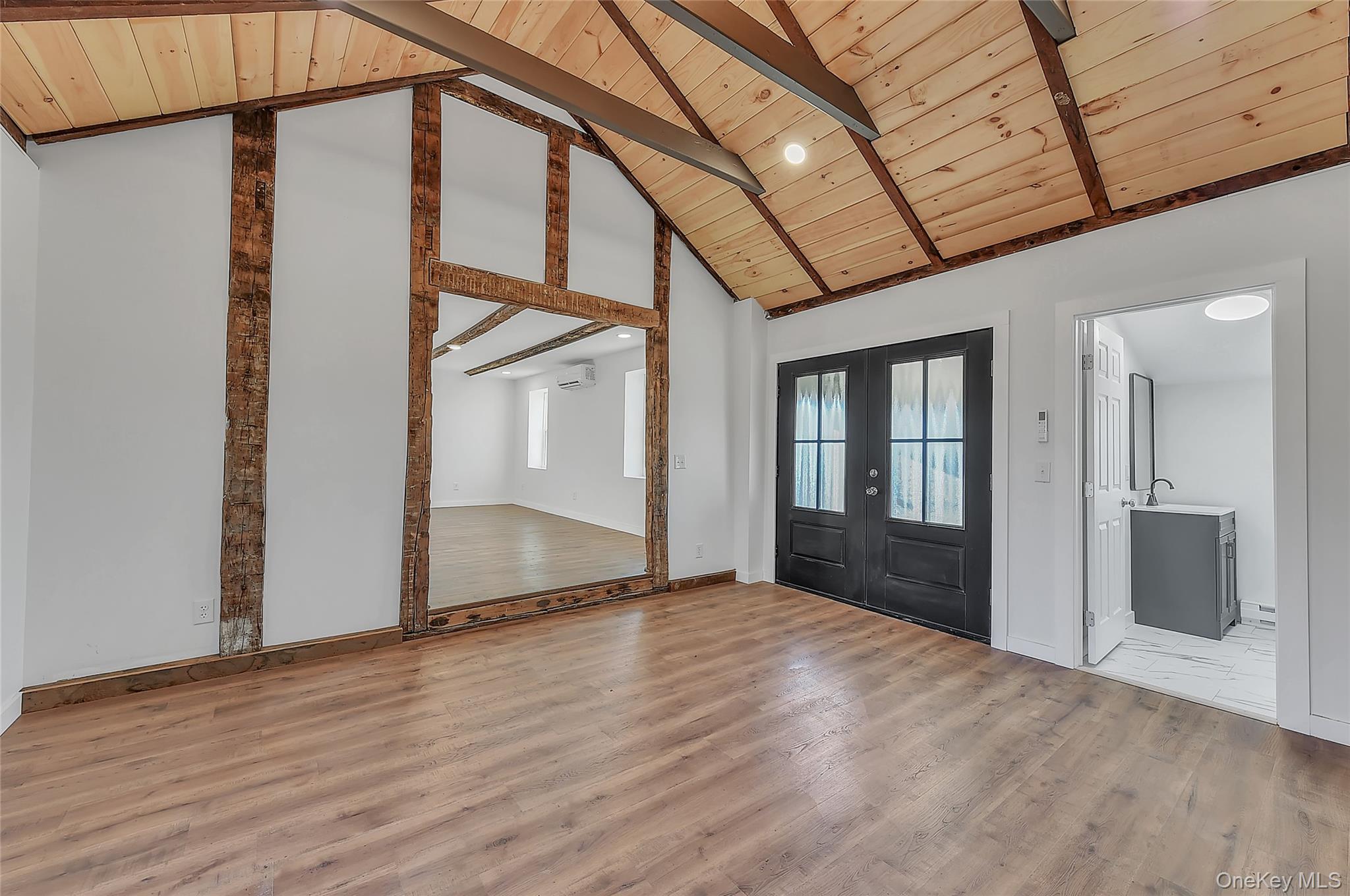 67 Jacobs Road Westtown, NY 10998 - Photo 15 of 36 Foyer entrance featuring french doors, light wood-style floors, high vaulted ceiling, and a wooden ceiling with exposed beams