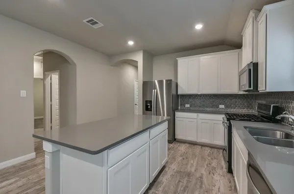 a kitchen with a sink and refrigerator