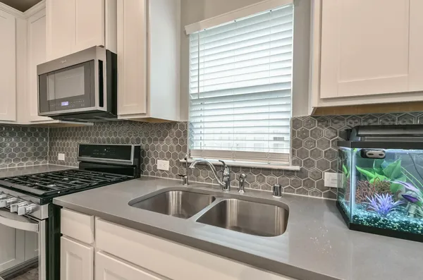 a kitchen with sink a microwave and stove