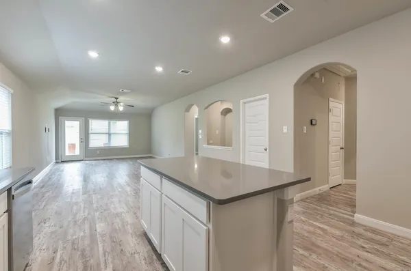 wooden floor with a window in a hall with an entryway