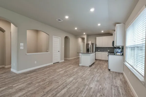 a view of kitchen with cabinets and wooden floor