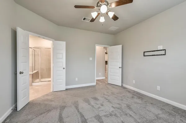 a view of a livingroom with a chandelier fan and windows