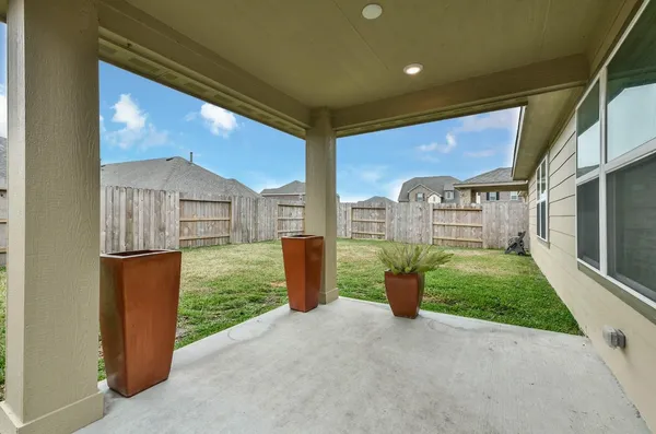a view of a porch with furniture and garden