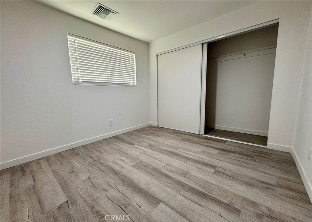 1362 South Downey Road Los Angeles, CA 90023 - Photo 21 of 30 a view of an empty room with wooden floor and a window