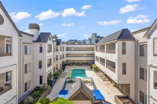 a living room with furniture a fireplace and a potted plant