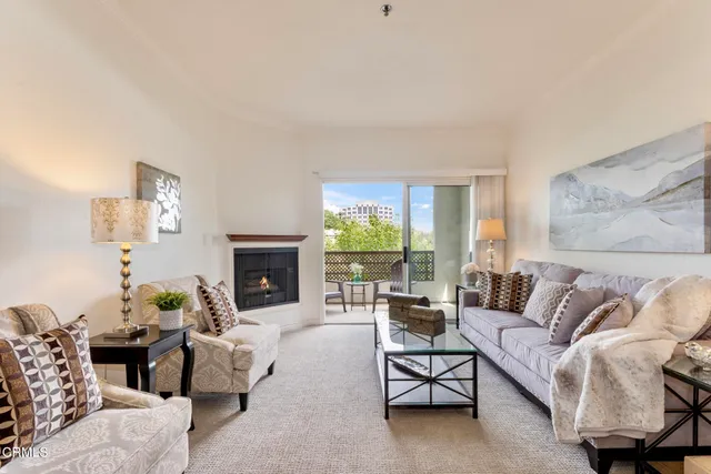 a kitchen with granite countertop a stove a sink and a refrigerator