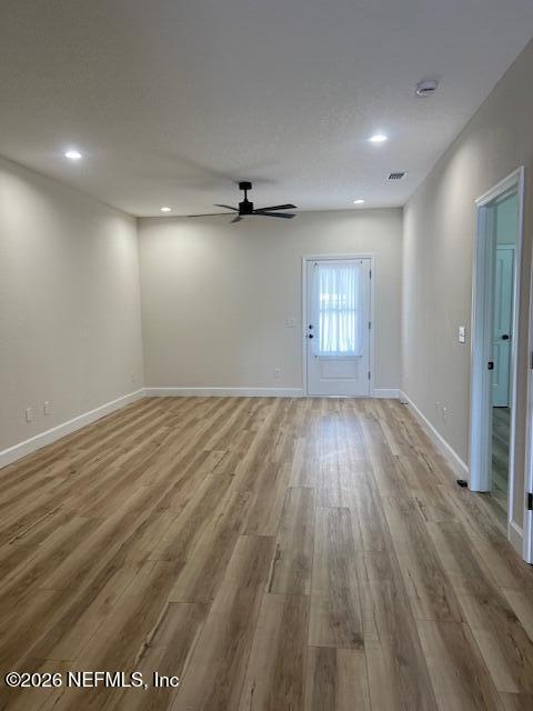 687 South Orange Street Starke, FL 32091 - Photo 7 of 13 an empty room with wooden floor and windows