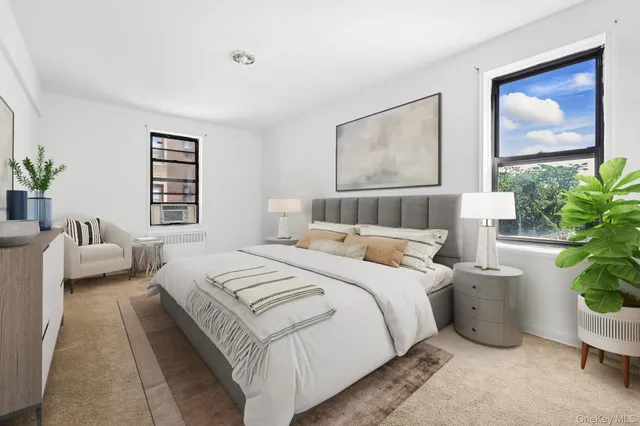 a bedroom with a large bed and a potted plant