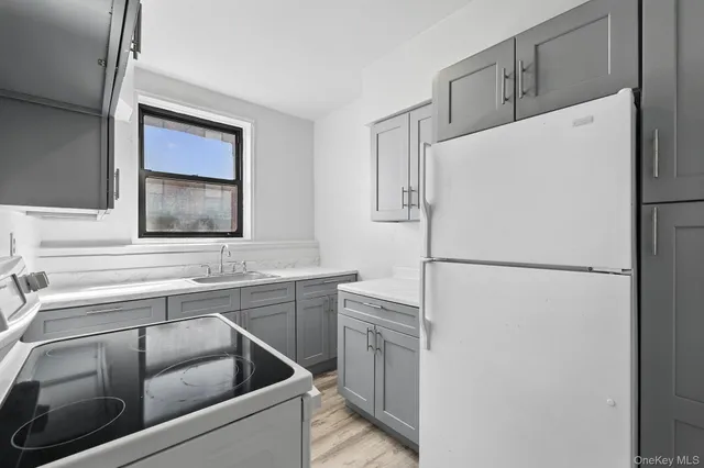a white refrigerator freezer sitting inside of a kitchen
