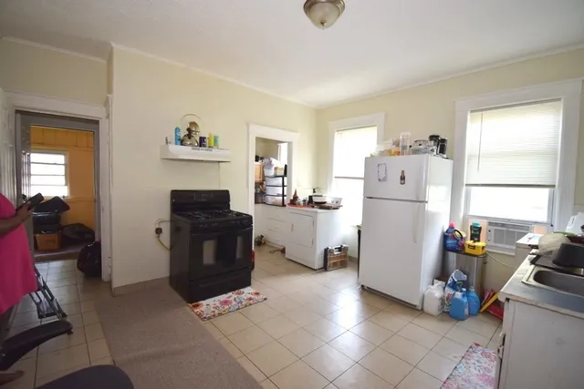 a kitchen with a refrigerator and cabinets