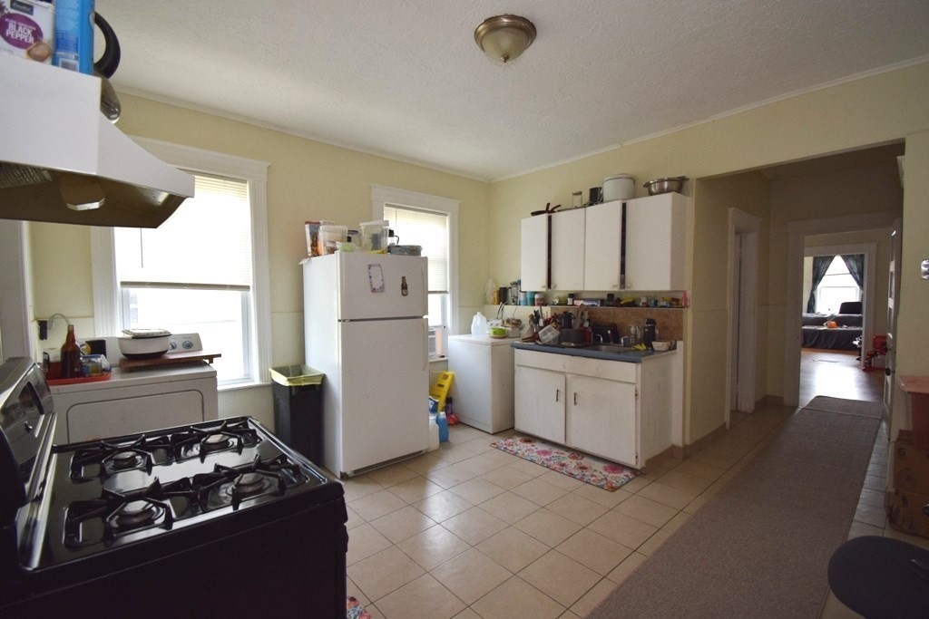 6 Pelham Street Worcester, MA 01609 - Photo 5 of 23 a kitchen with a stove and a refrigerator