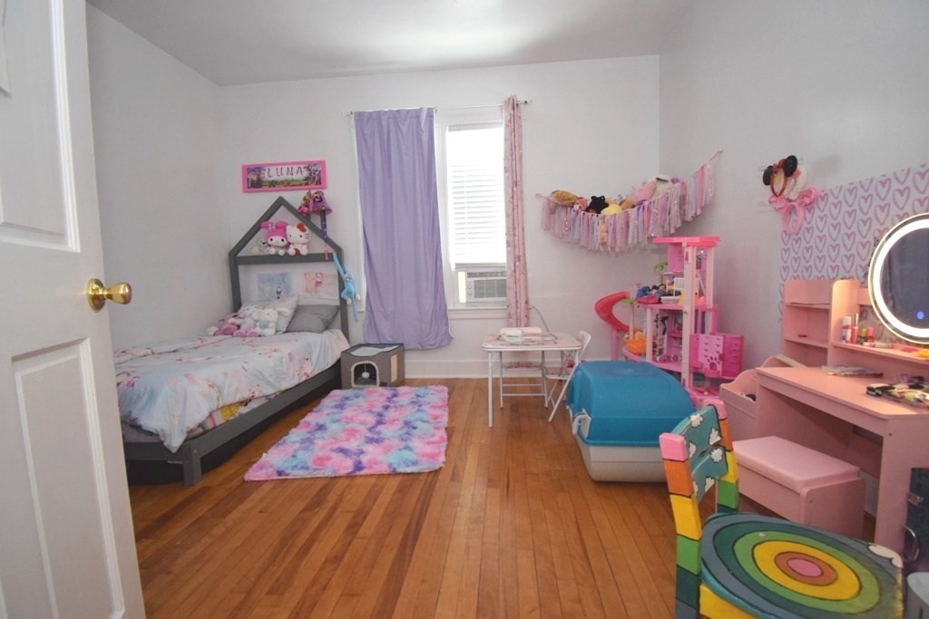 6 Pelham Street Worcester, MA 01609 - Photo 7 of 23 a bedroom with bed and a wooden floor