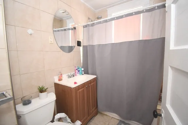a bathroom with a sink mirror vanity and toilet